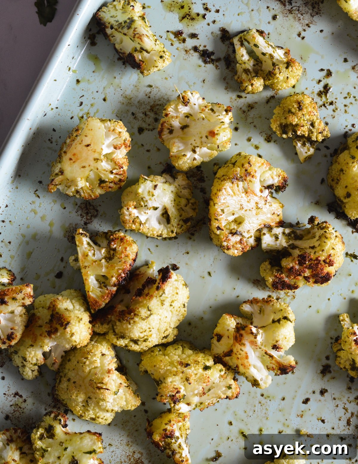 Herb roasted cauliflower florets on a sheet pan. 