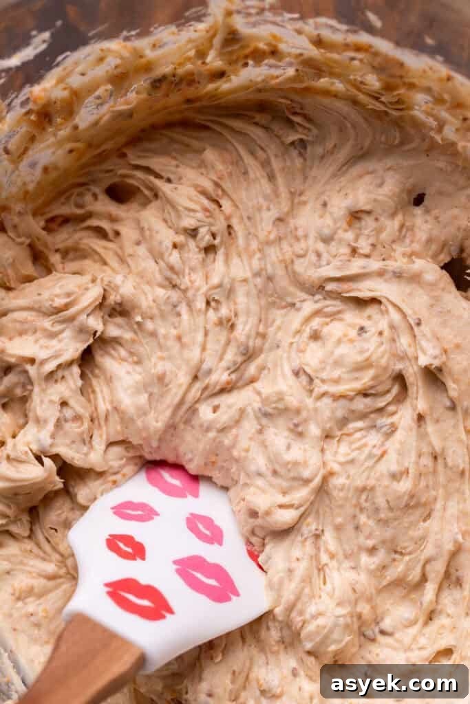 Butterfinger cream cheese frosting in a glass bowl.