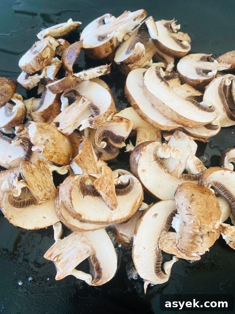 Blackstone Steak and Mushroom Quesadilla Recipe 6 mushrooms on the griddle before cooking
