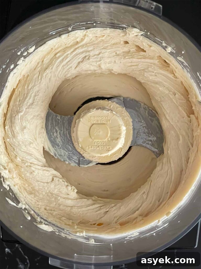 Silky Ricotta Mousse Recipe with Lemon and Honey 5 Ricotta mousse whipped in the bowl of a food processor.