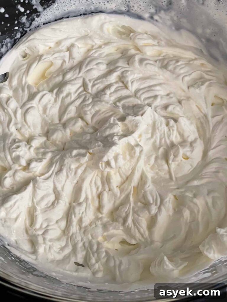 Silky Ricotta Mousse Recipe with Lemon and Honey 6 Whipped heavy cream in a glass mixing bowl.