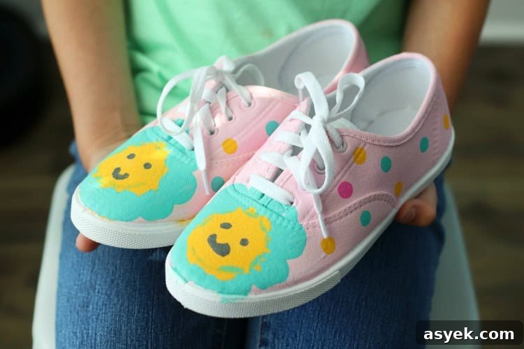 child holding pair of painted shoes