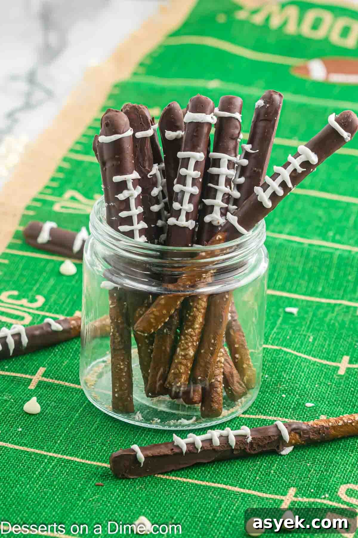 Football Chocolate Covered Pretzel Rods in a glass jar