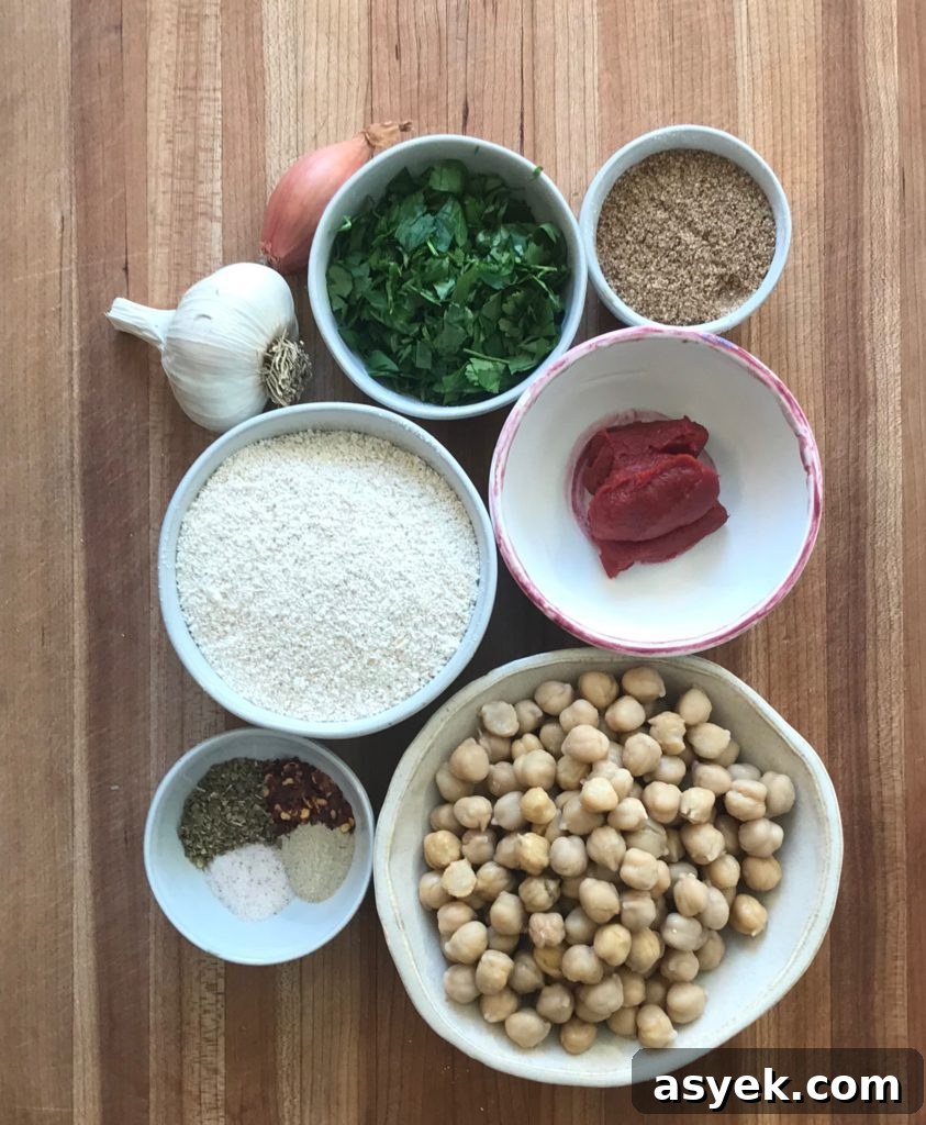 Ingredients for vegan meatballs: fresh parsley, garlic, shallot, ground flax, ground oats, tomato paste, chickpeas and spices.