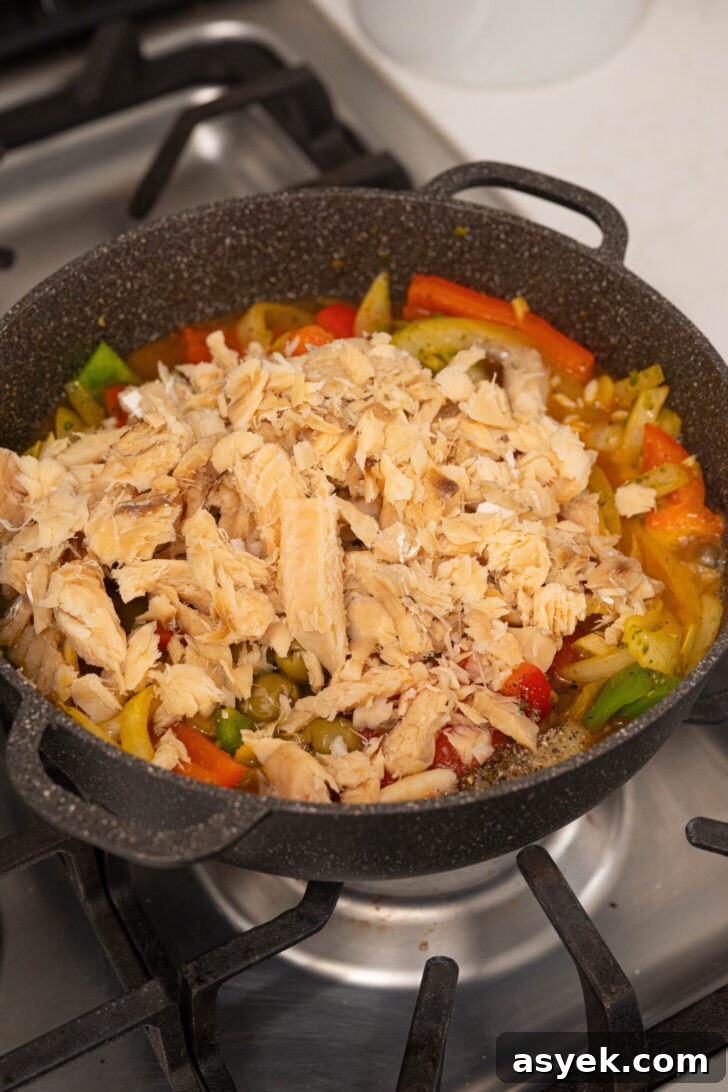 A pot with salted codfish and veggies.