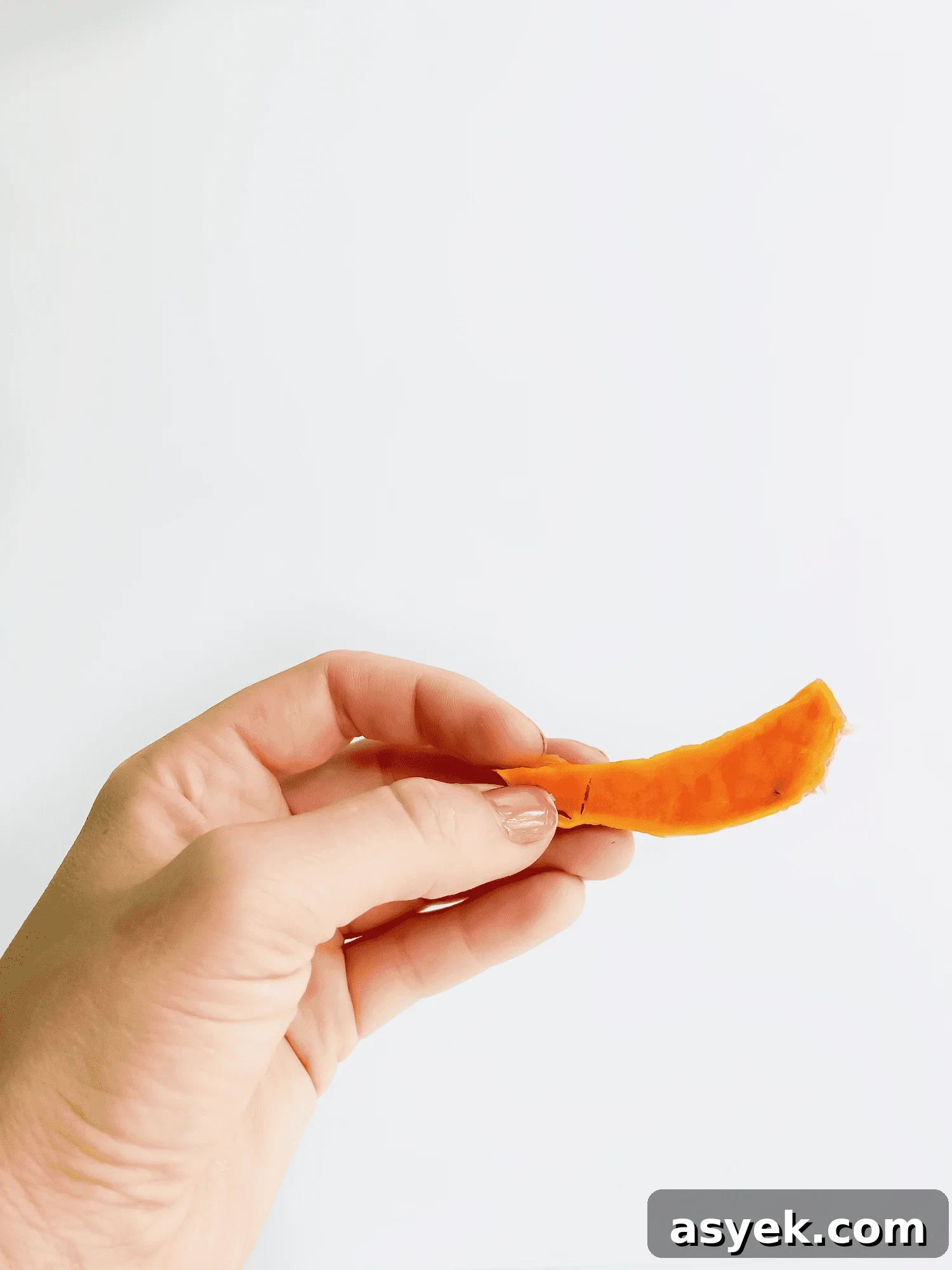 Baby first foods 4 to 6 months with hand holding sweet potato for baby