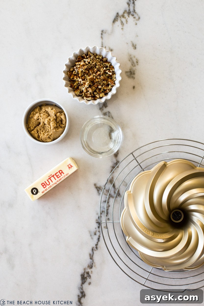 Classic Pecan Pie Bundt Cake Recipe 5 Overhead photo of ingredients for a pecan pie topping for a bundt cake on a white marble background