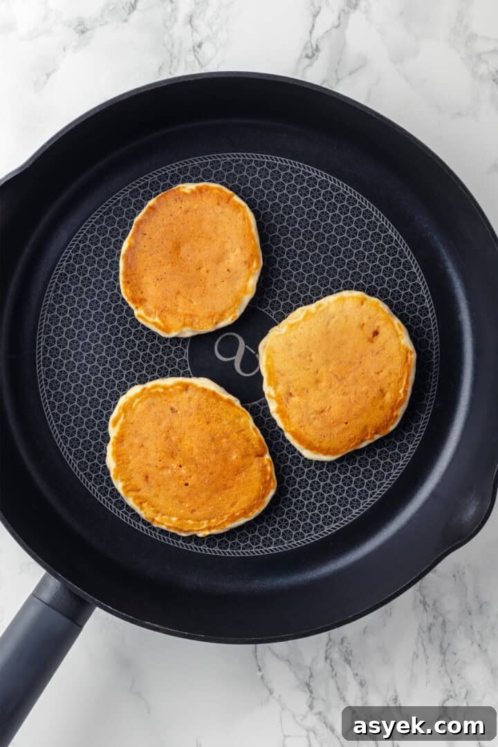 Overhead view of banana pancakes in skillet