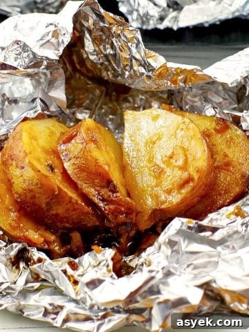 cooked, sliced, onion baked potato on foil