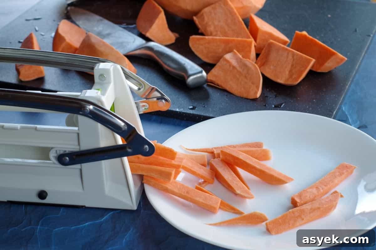 sweet potato fries being cut with a chipper