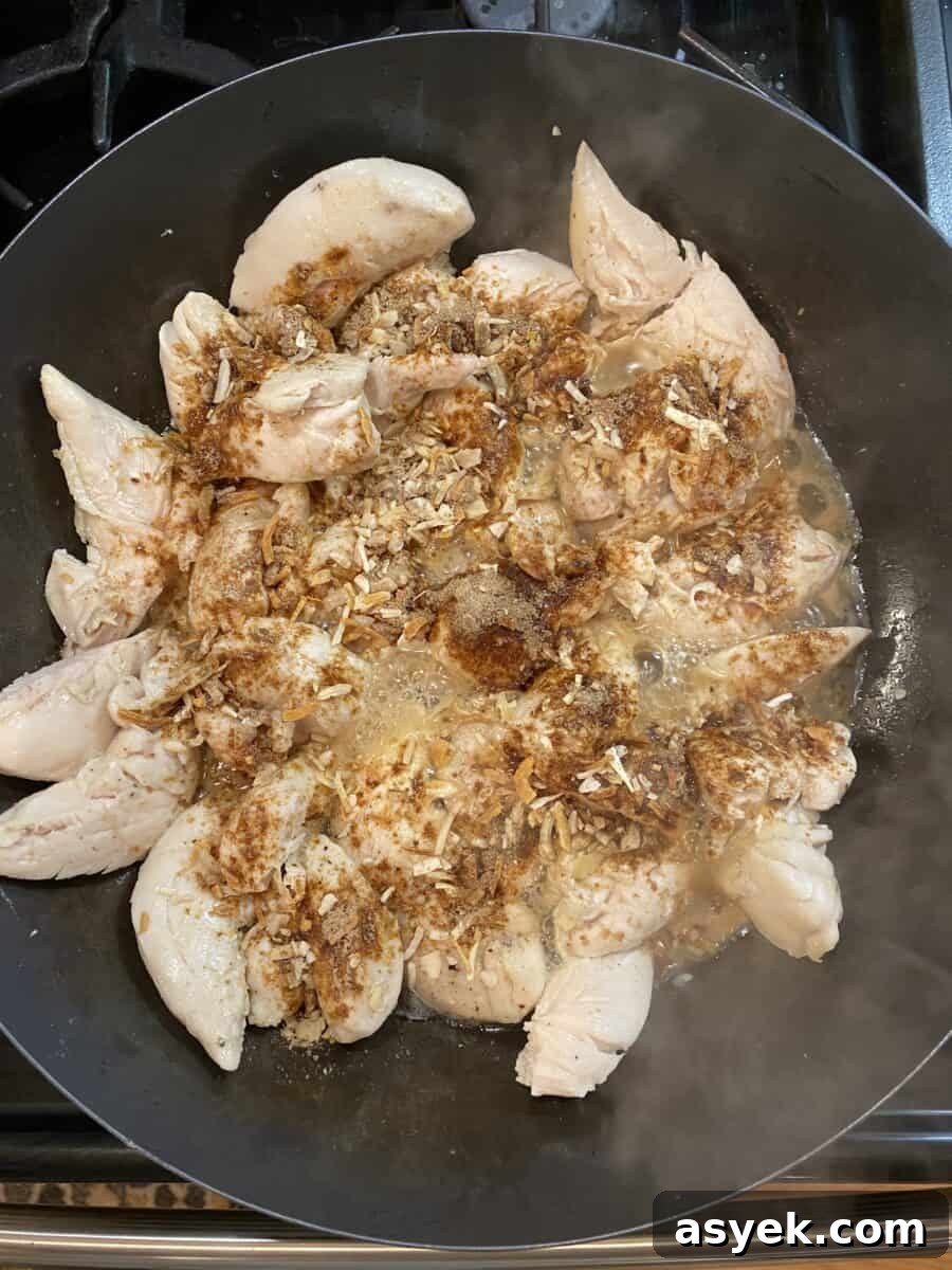 Onion soup mix sprinkled on top of cooked chicken in a skillet