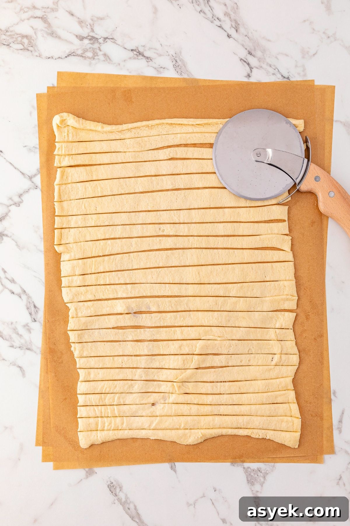 Halloween Mummy Hot Dogs Recipe 4 Crescent dough rolled out and cut into small strips with a pizza cutter.