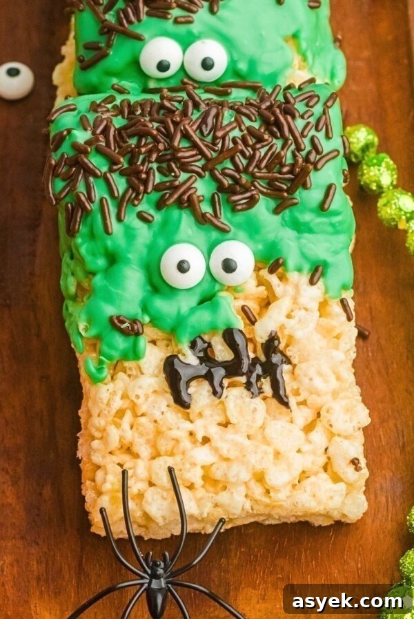 Decorated Frankenstein rice krispies treats on a wooden board.