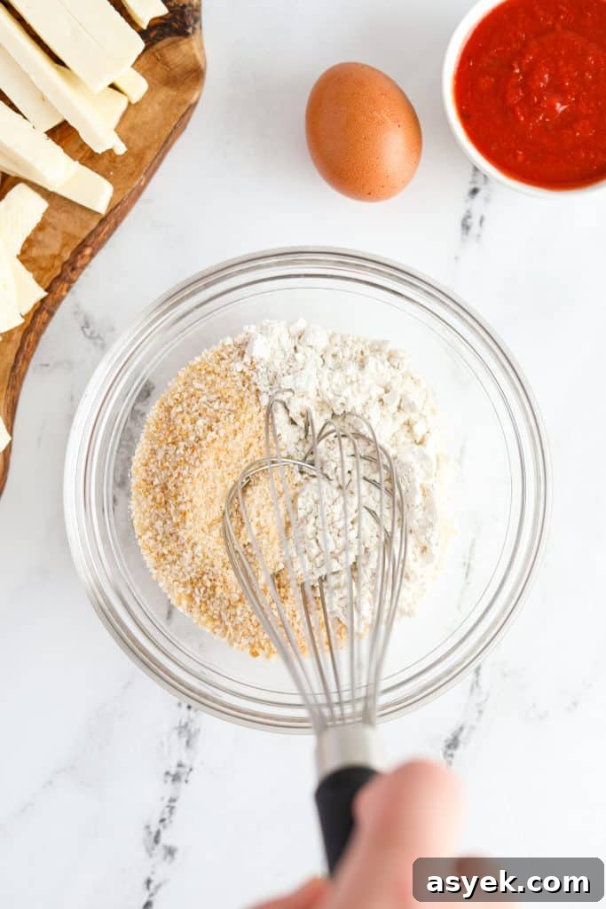 Crispy Air Fryer Halloumi Fries 5 Whisking together flour and breadcrumbs.