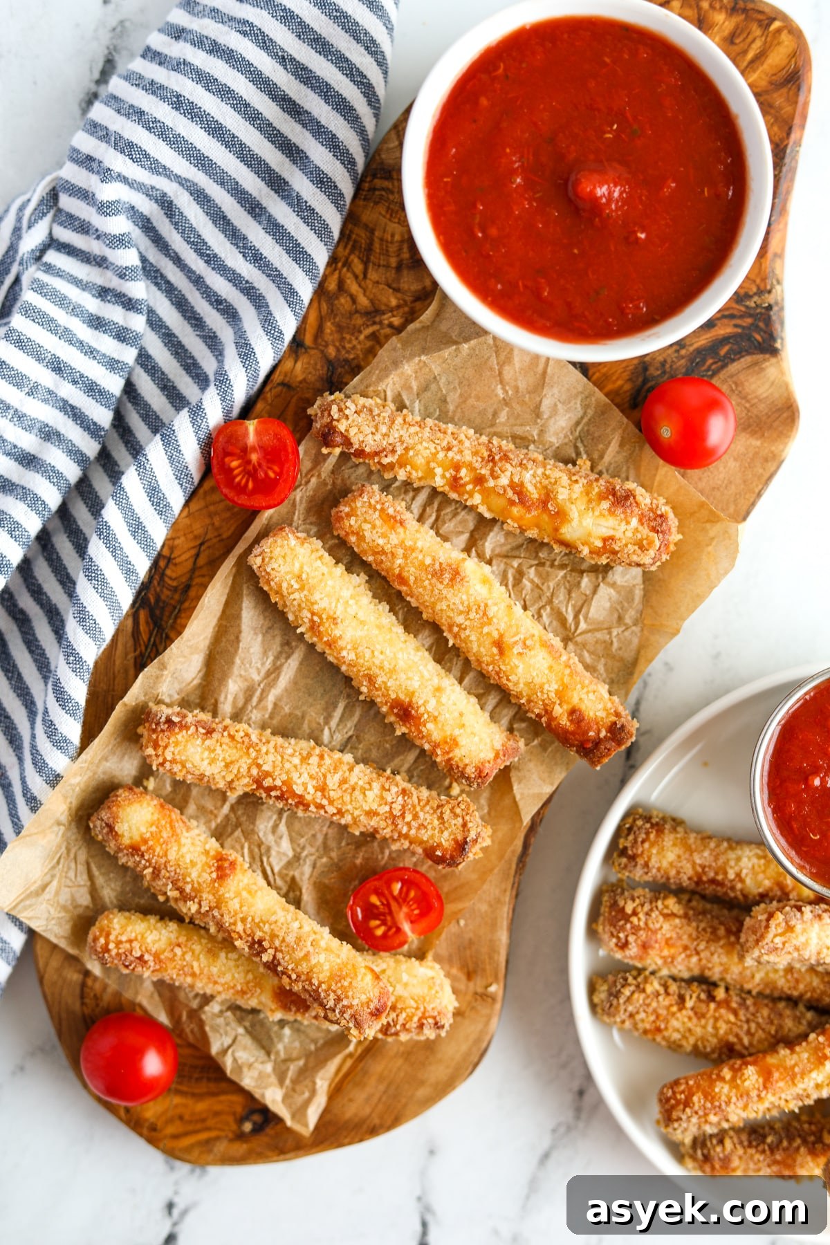 Crispy Air Fryer Halloumi Fries 6 A wooden platter filled with halloumi fries and a small bowl of pizza sauce.