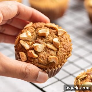 High-Protein Almond Flour Banana Muffins: Gluten-Free Snacks 11 almond flour banana muffin held in a hand with cashews on top