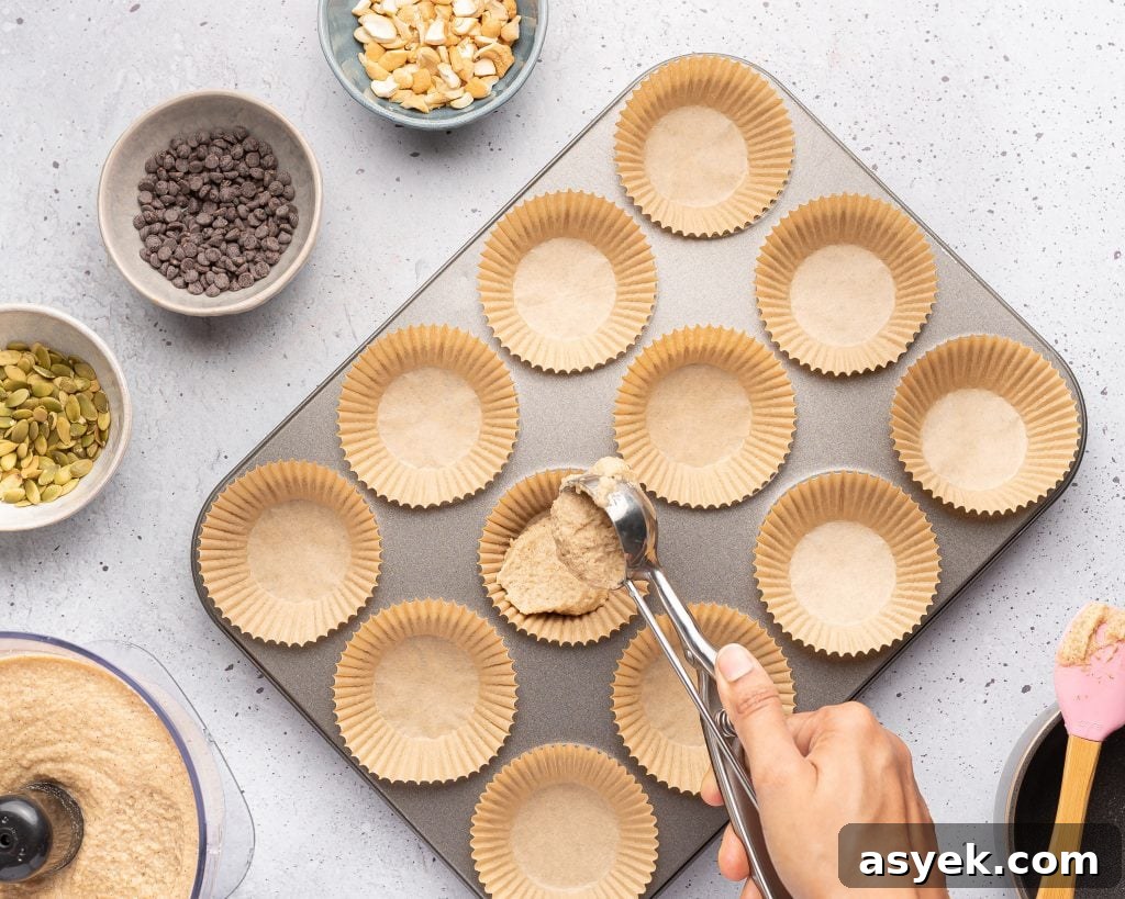 High-Protein Almond Flour Banana Muffins: Gluten-Free Snacks 6 filling a muffin tin with almond flour banana batter