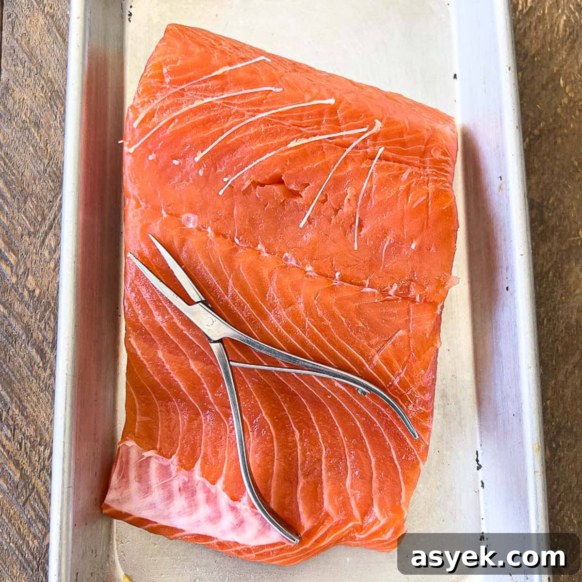 How to Skin Salmon Fillets: Step-by-Step 5 Removing pin bones from raw salmon with pliers.