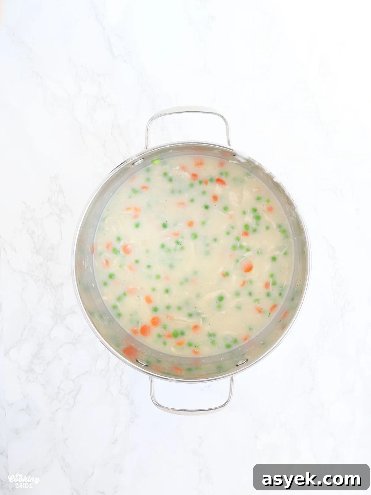 overhead shot of pot pie filling in a stainless steel stock pot