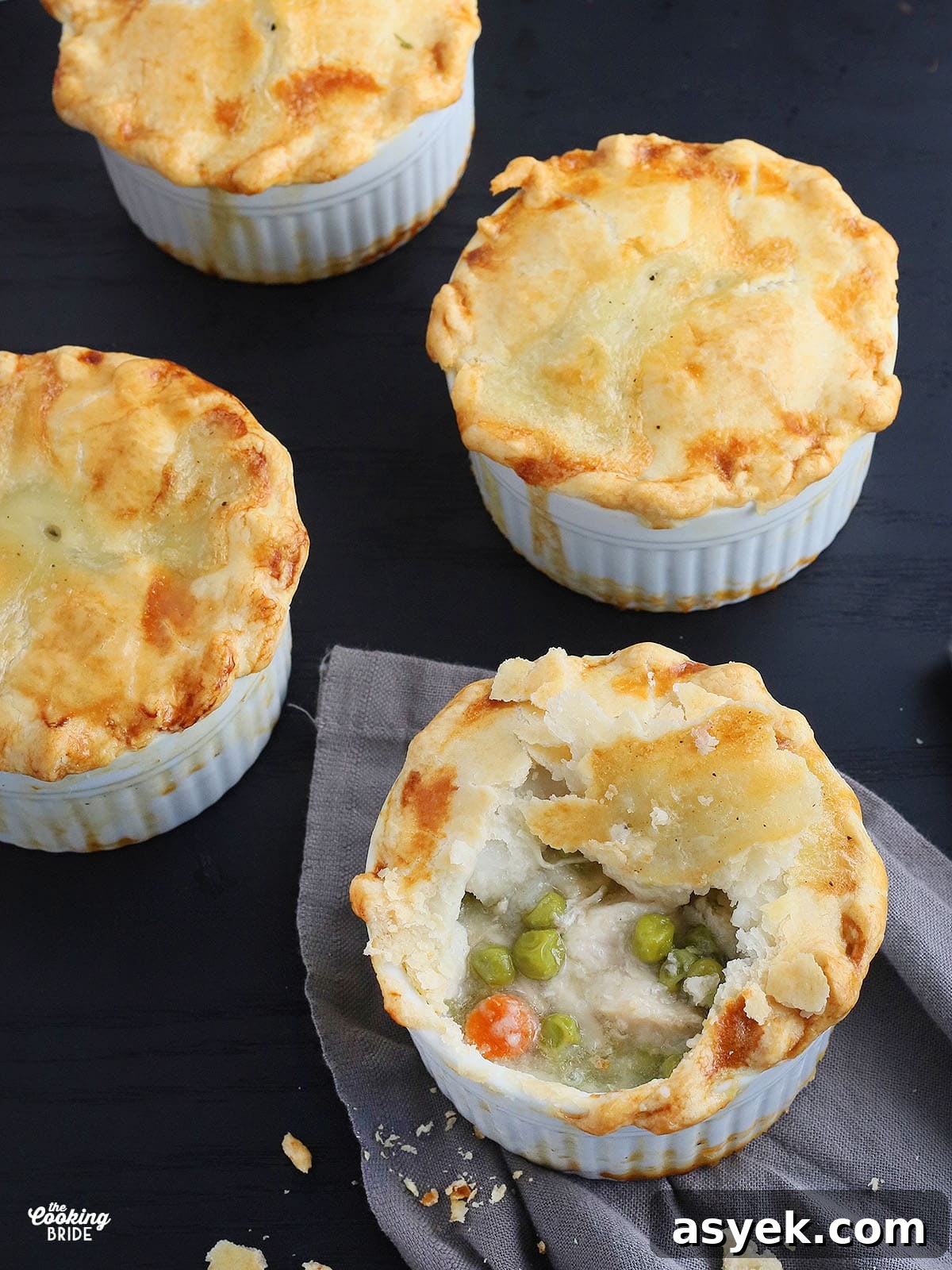 a mini chicken pot pie with a spoonful removed to show the filling