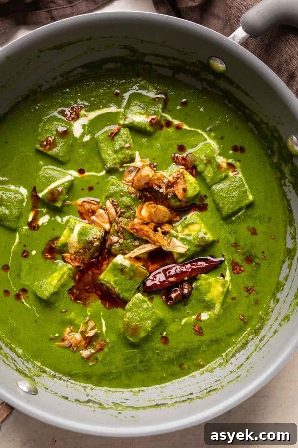 Palak paneer pictures in the pan that it was cooked in with garlic tadka on top
