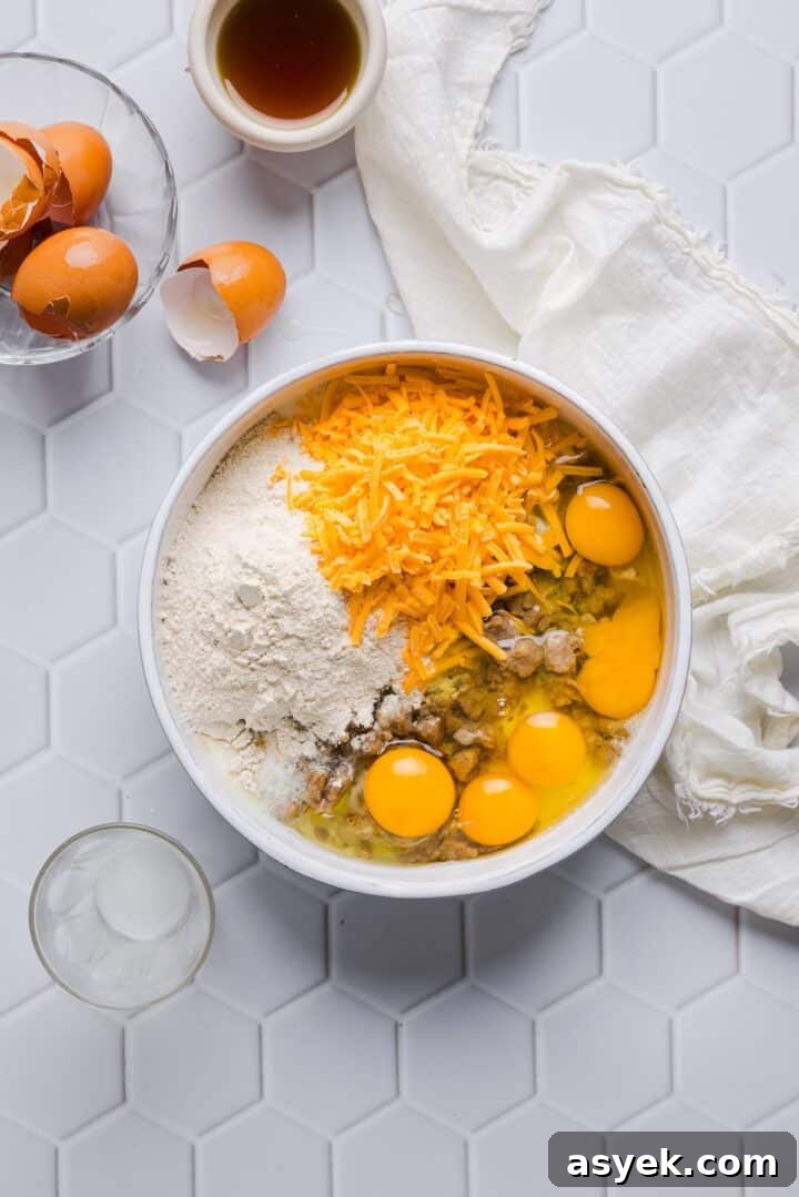 Ingredients for protein mcgriddle muffins in a large white bowl, unmixed.