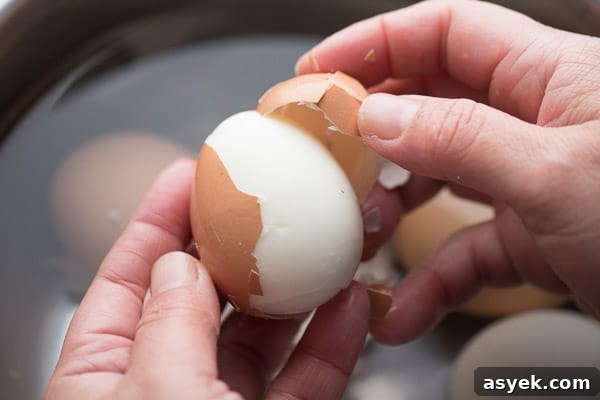 How to Peel Hard-Boiled Eggs Perfectly Every Time 7 Peeling the shell away from the egg