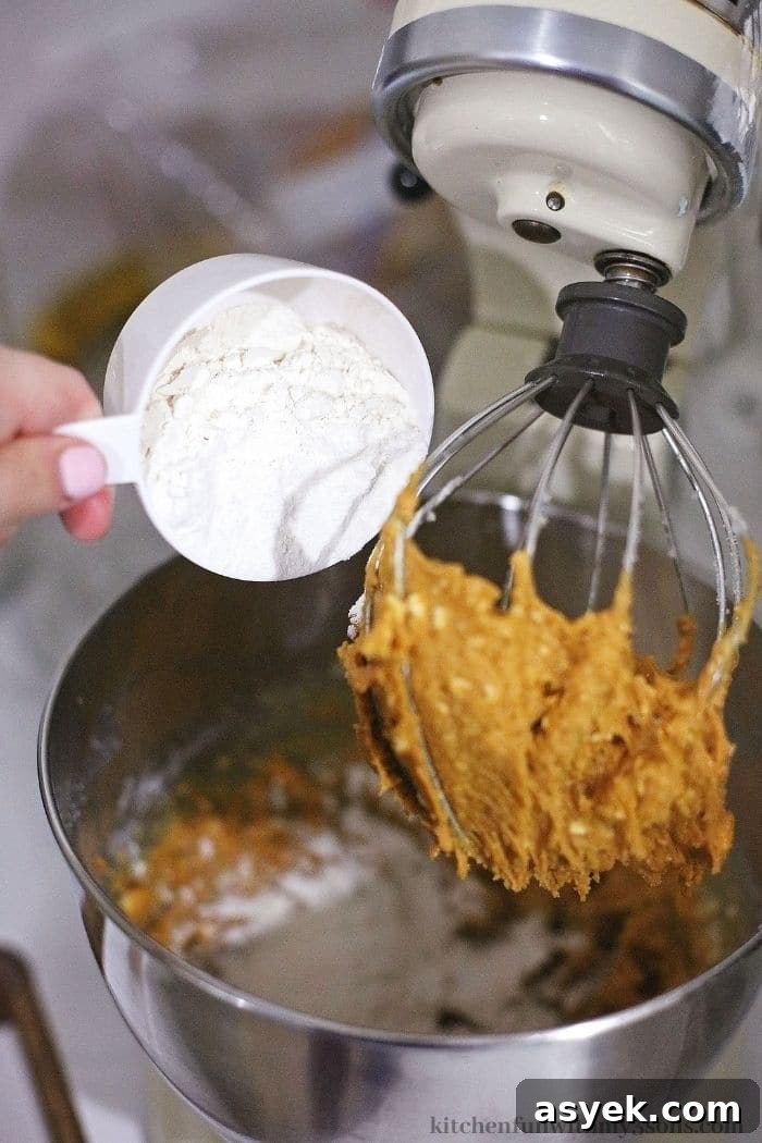 Classic Peanut Butter Sandwich Cookies with Creamy Filling 5 Adding in the flour.