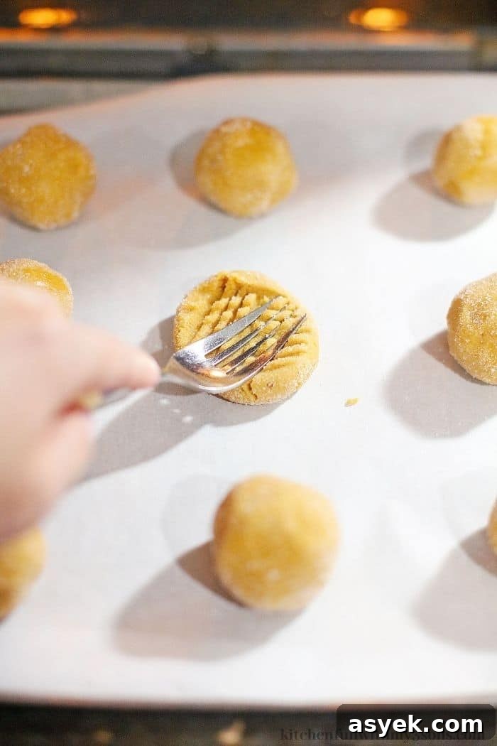 Classic Peanut Butter Sandwich Cookies with Creamy Filling 6 Pressing the cookies down using a fork.