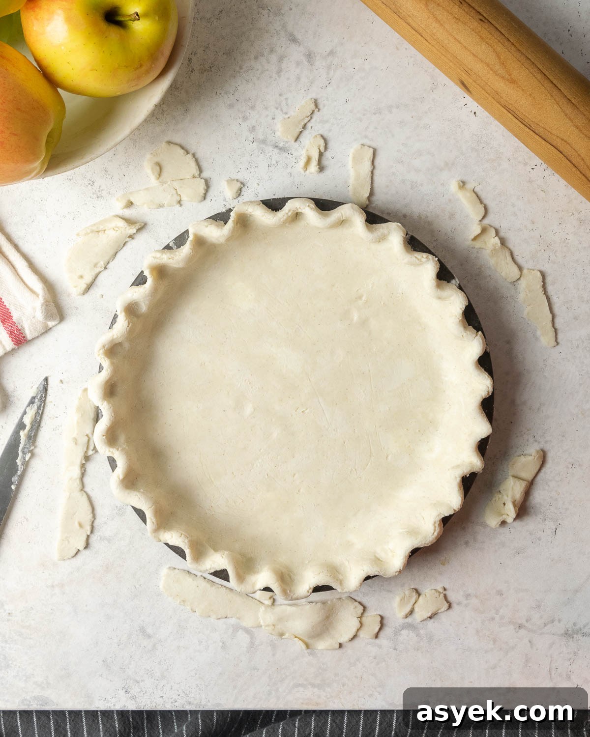 An unbaked gluten free pie crust in a pie tin.