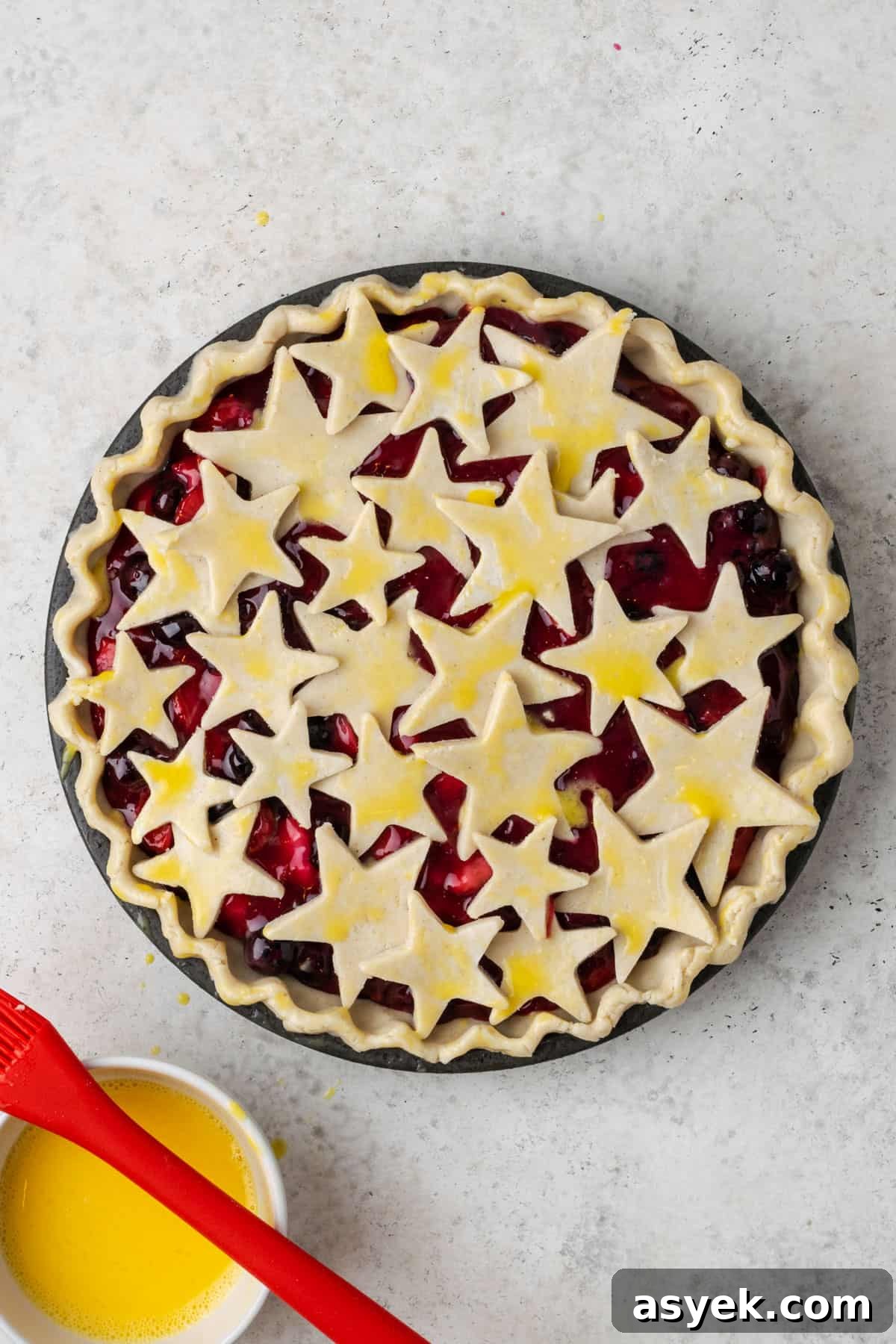 A decorative pie crust made from different size star cut outs.
