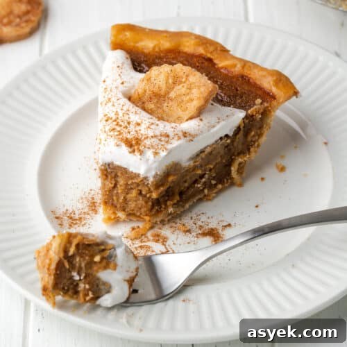 A slice of apple butter pie on a white plate.