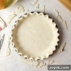 An unbaked pie crust in a pie tin.
