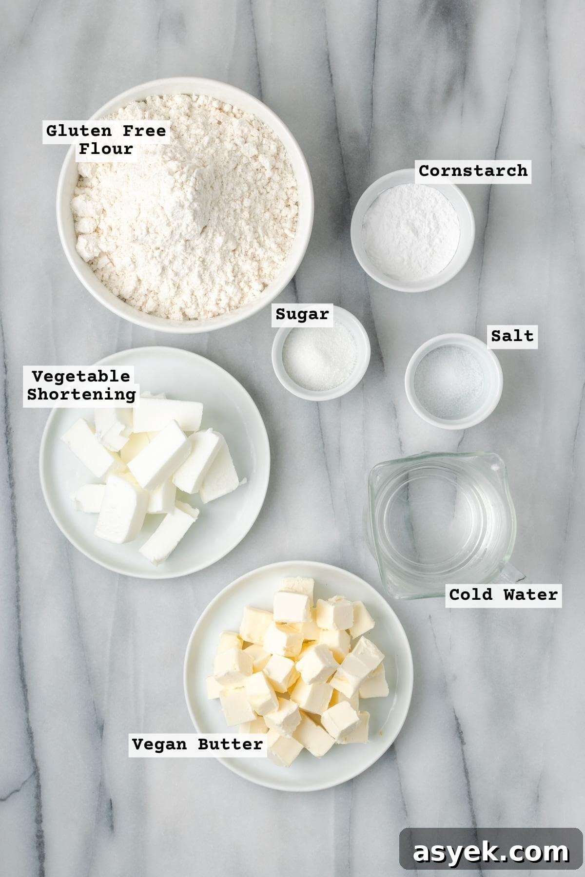 Ingredients for gluten free pie crust on a white marble table.