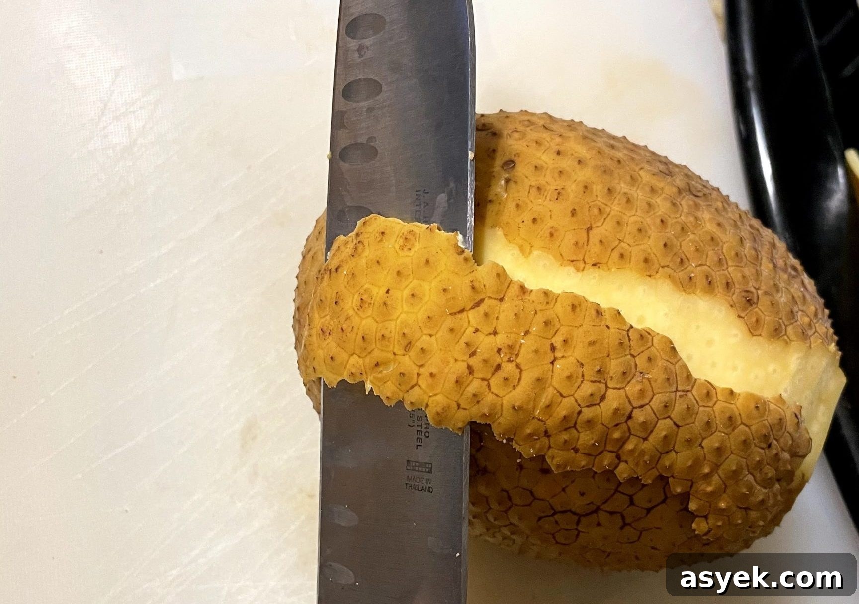 Peel breadfruit with paring knife