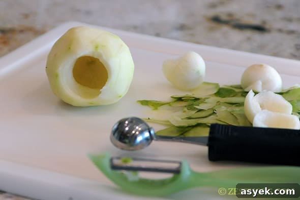 cutting board with pear cores scooped out