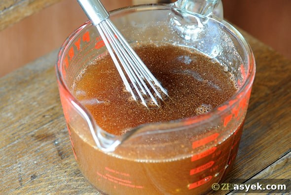 syrup in a measuring cup with a whisk