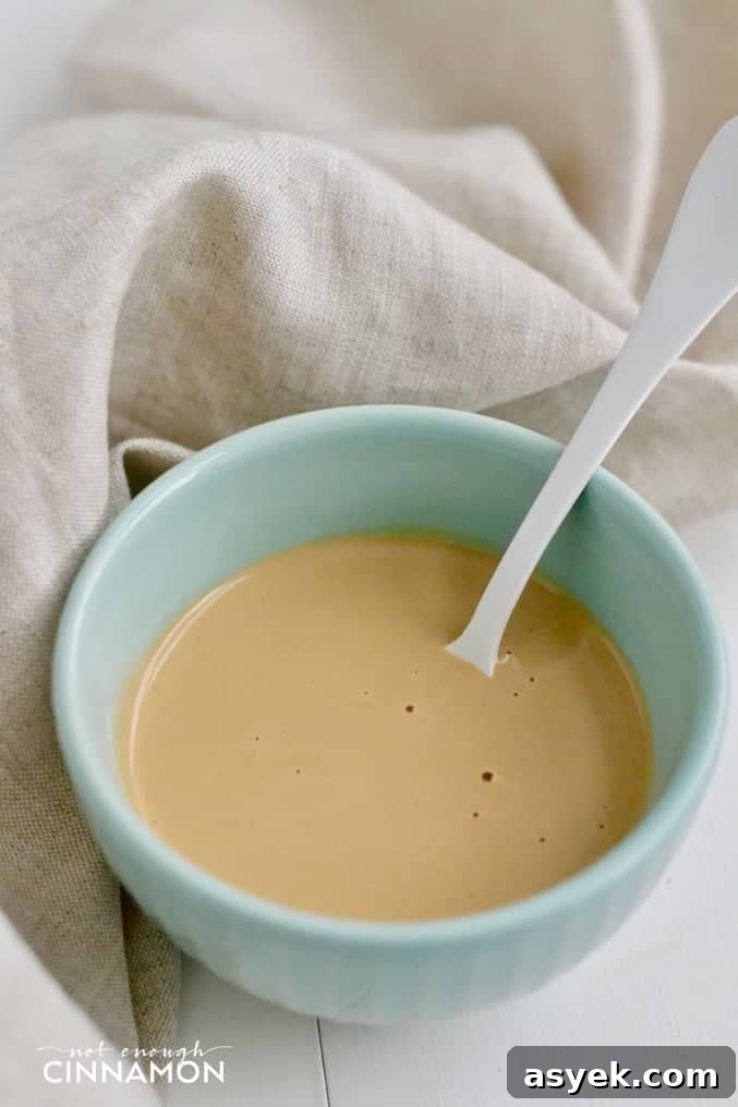a small turquoise dish with creamy tahini dressing 