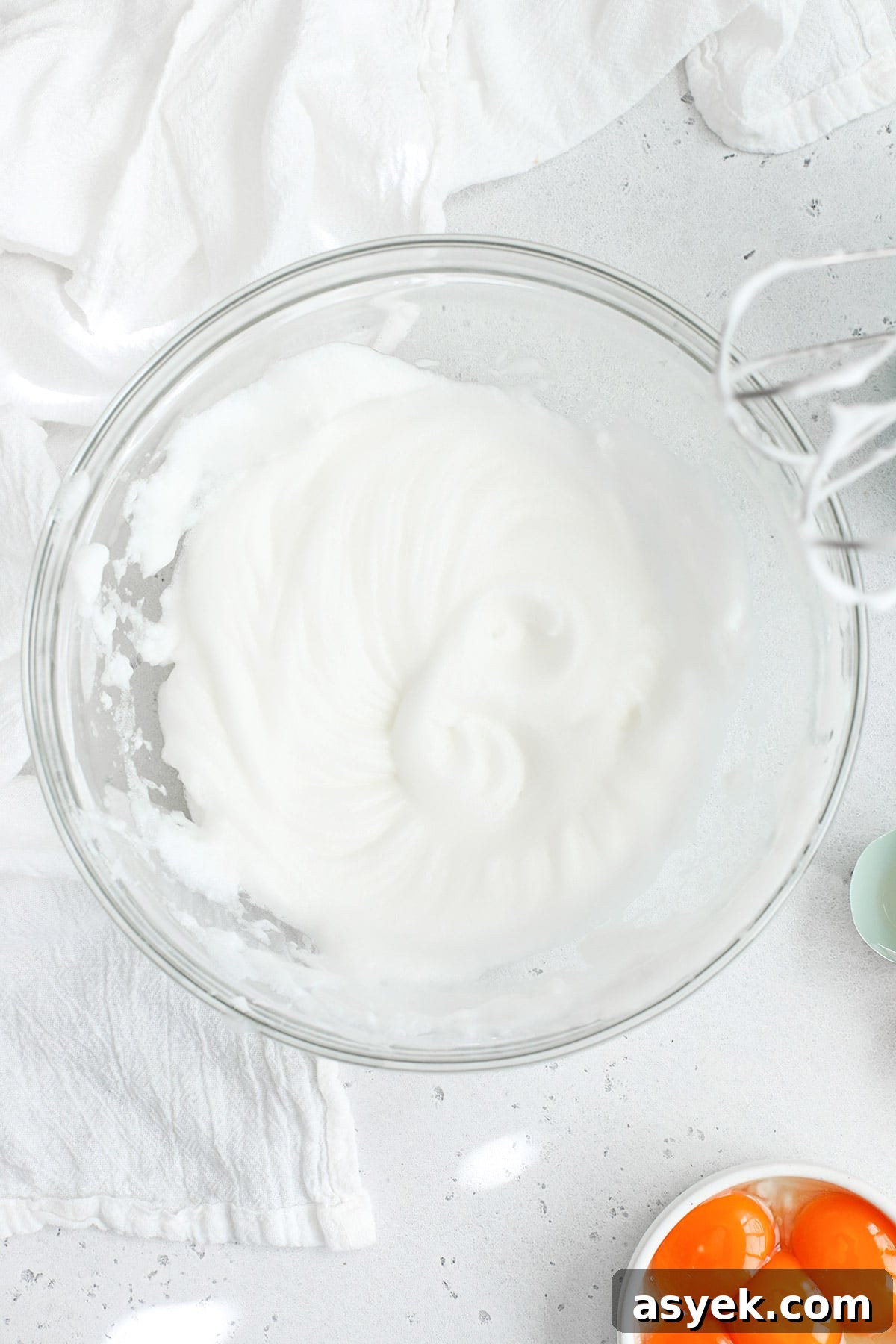 Overhead view of egg whites whipped to soft peaks