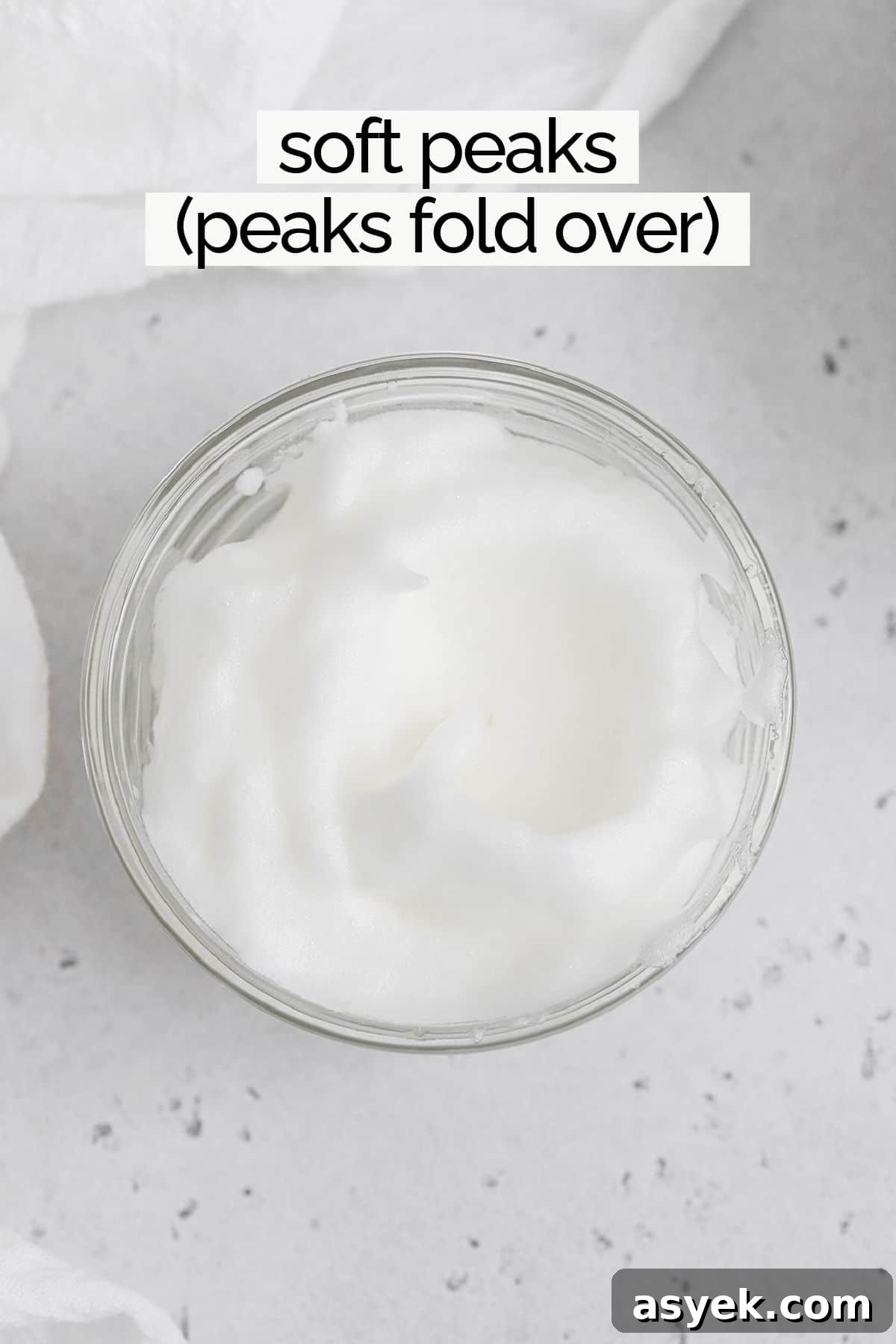 Overhead view of egg whites whipped to soft peaks
