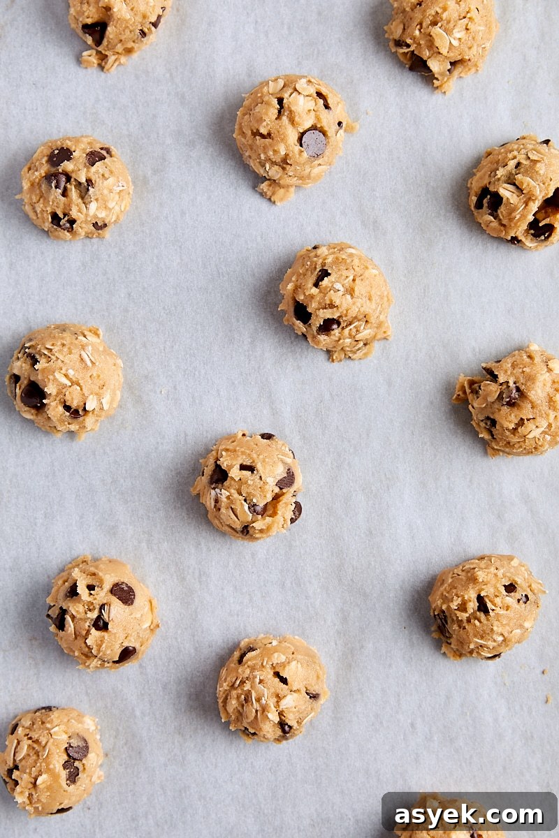 Small Batch Oatmeal Chocolate Chip Cookies Recipe 12 Cookie dough balls scooped onto parchment-lined baking sheet