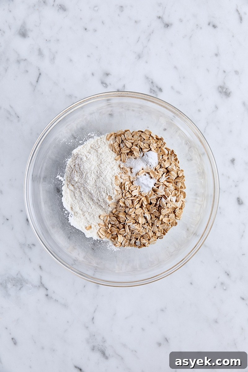 Small Batch Oatmeal Chocolate Chip Cookies Recipe 4 Flour, oats, baking soda, cornstarch, and salt in glass bowl