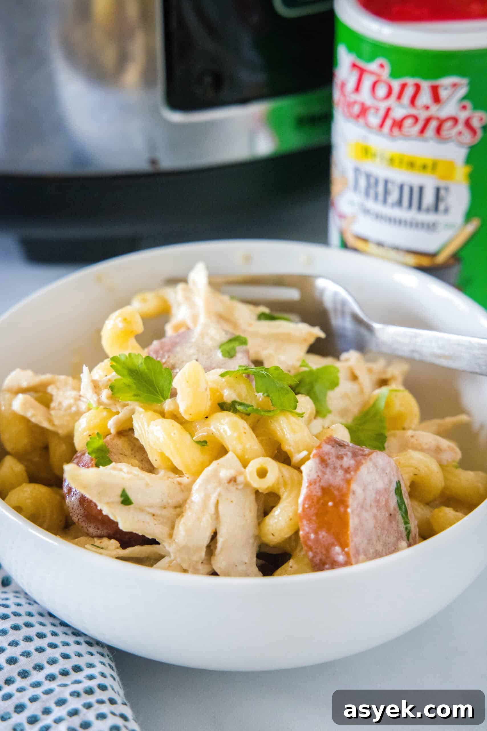 Crockpot Cajun chicken pasta in a bowl with a fork.