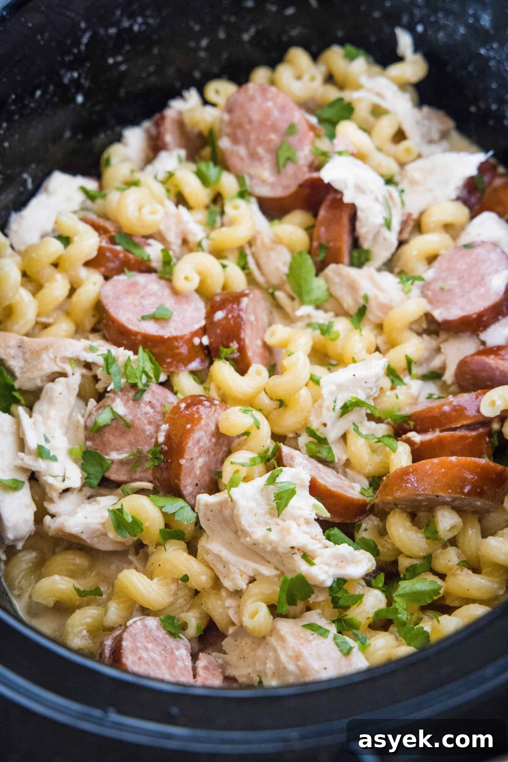 Overhead view of crockpot Cajun chicken pasta inside the slow cooker.