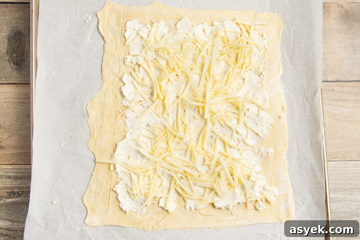 Asparagus and Boursin Puff Pastry Tart Recipe 7 This is a picture of the puff pastry with Boursin and shredded cheese added.