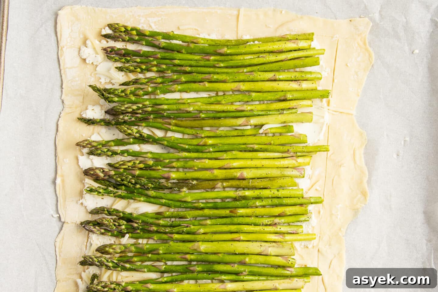 Asparagus and Boursin Puff Pastry Tart Recipe 8 This is a picture of the puff pastry with the cheese and asparagus added.