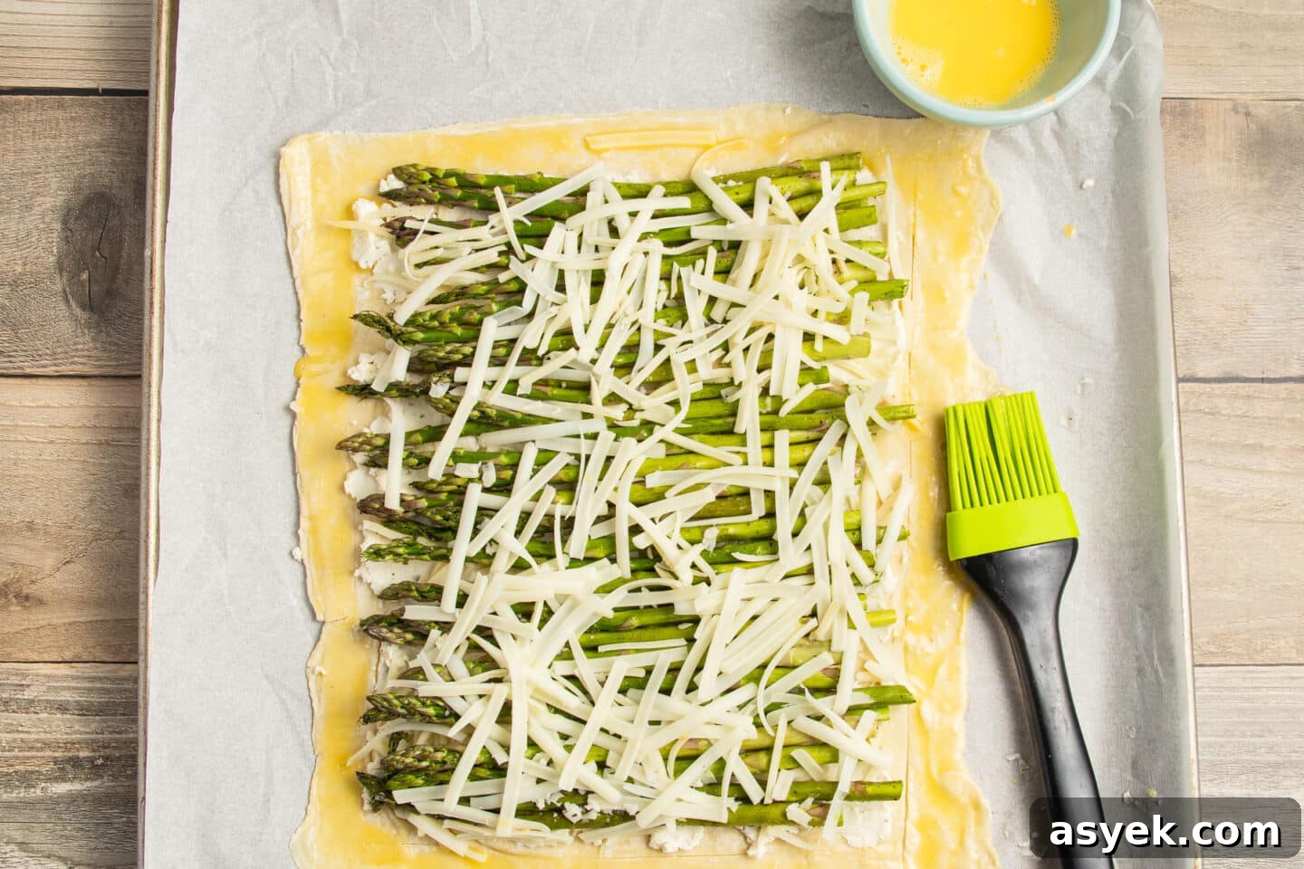 Asparagus and Boursin Puff Pastry Tart Recipe 10 This is a picture of the puff pastry with asparagus, cheese and egg wash around.
