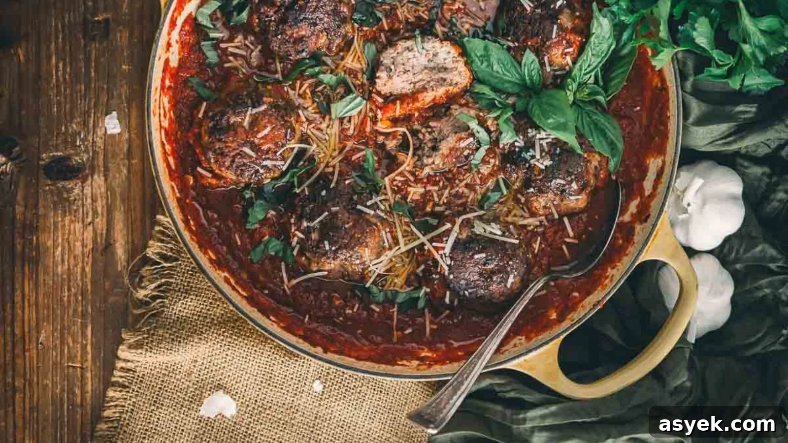 Polpette meatballs in rich tomato sauce simmering in a cast iron pan.