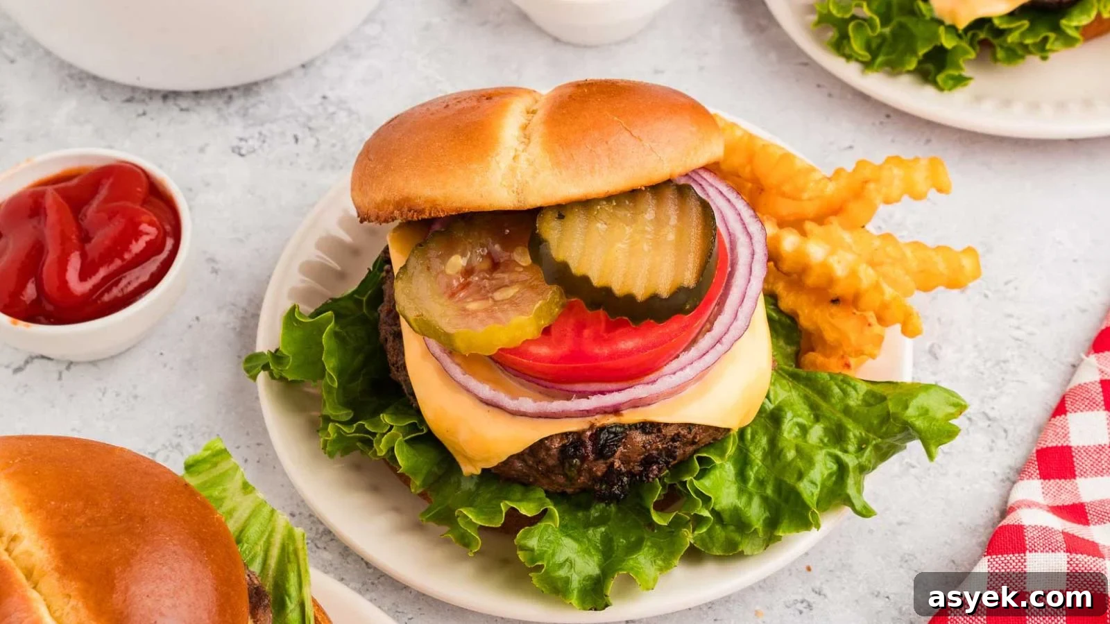Cowboy butter burgers stacked high with melted butter spread and herbs on toasted buns.