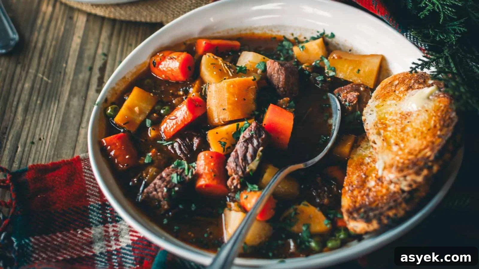 Guinness beef stew with deep rich broth and chunks of beef and vegetables.
